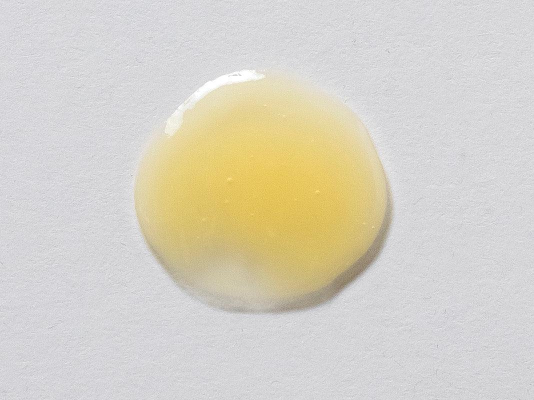 Peptide Eye Serum by RoZ Aesthetics, yellow serum drop on white background